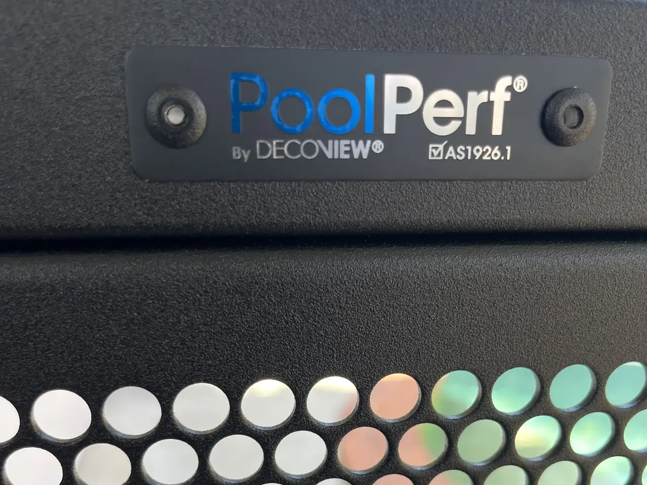 The PoolPerf plate on the top rail of a gate, marked By Decoview and AS1926.1, with the perforated panel below it