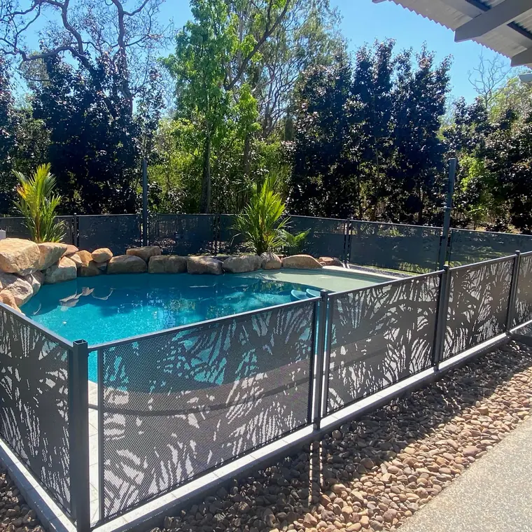 Ironstone grey PoolPerf panels with the Pandanus design around a rock pool in a bush garden