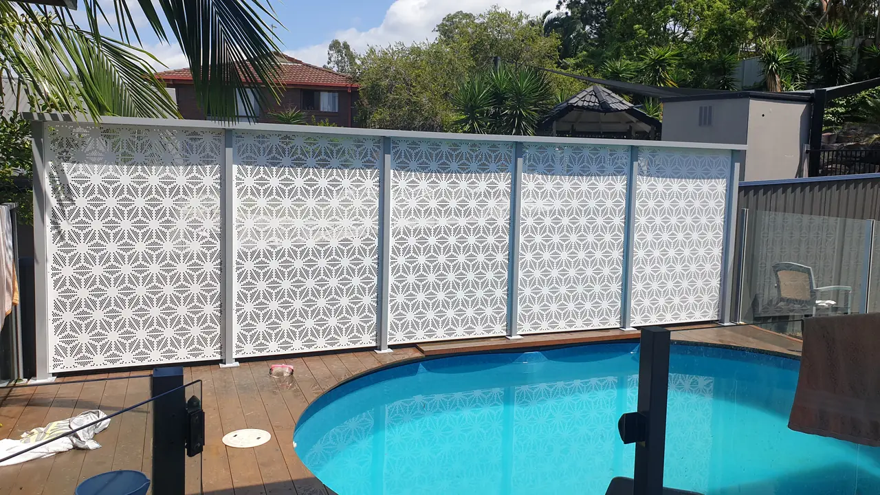 White patterned panels along a timber deck beside a round above-ground pool